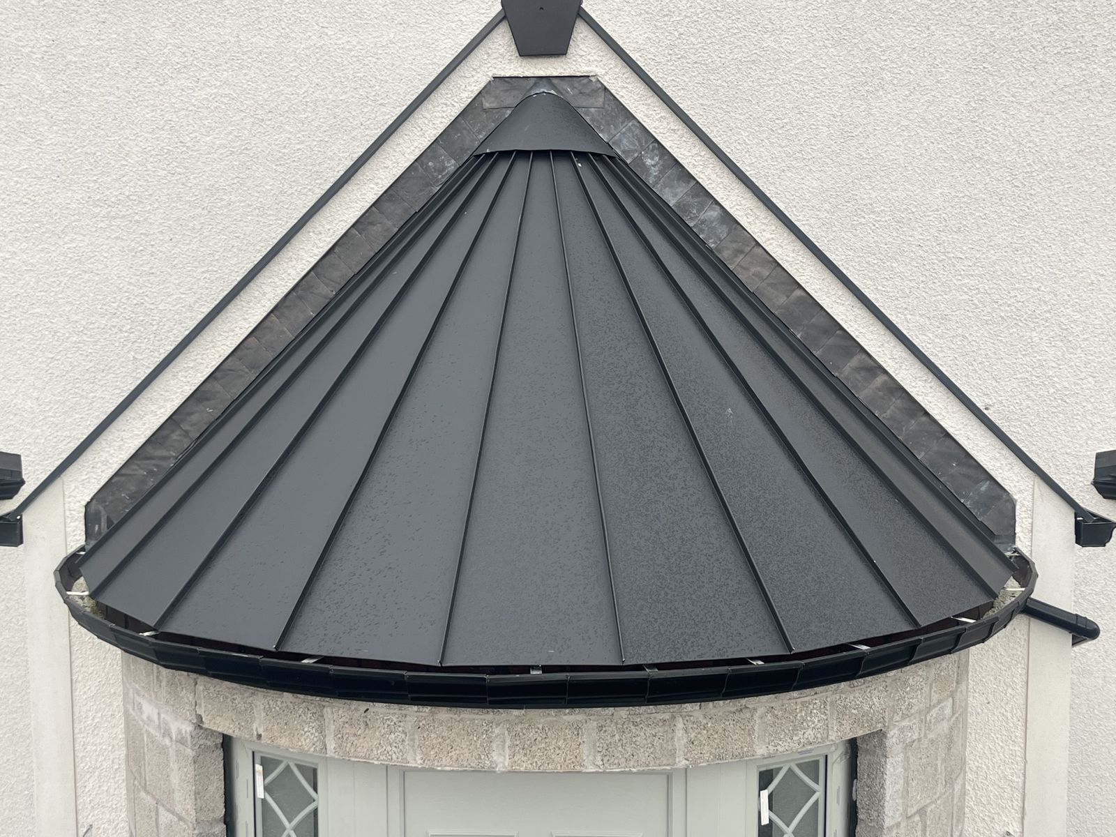Curved conical bay roof in Kalzip anthracite grey